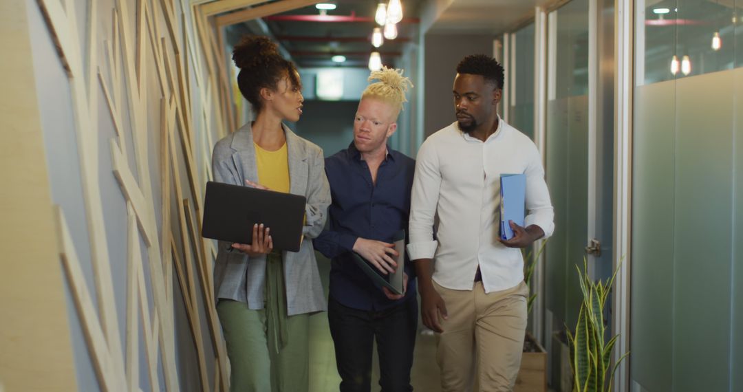 Diverse Business Team Collaborating in Modern Office Corridor