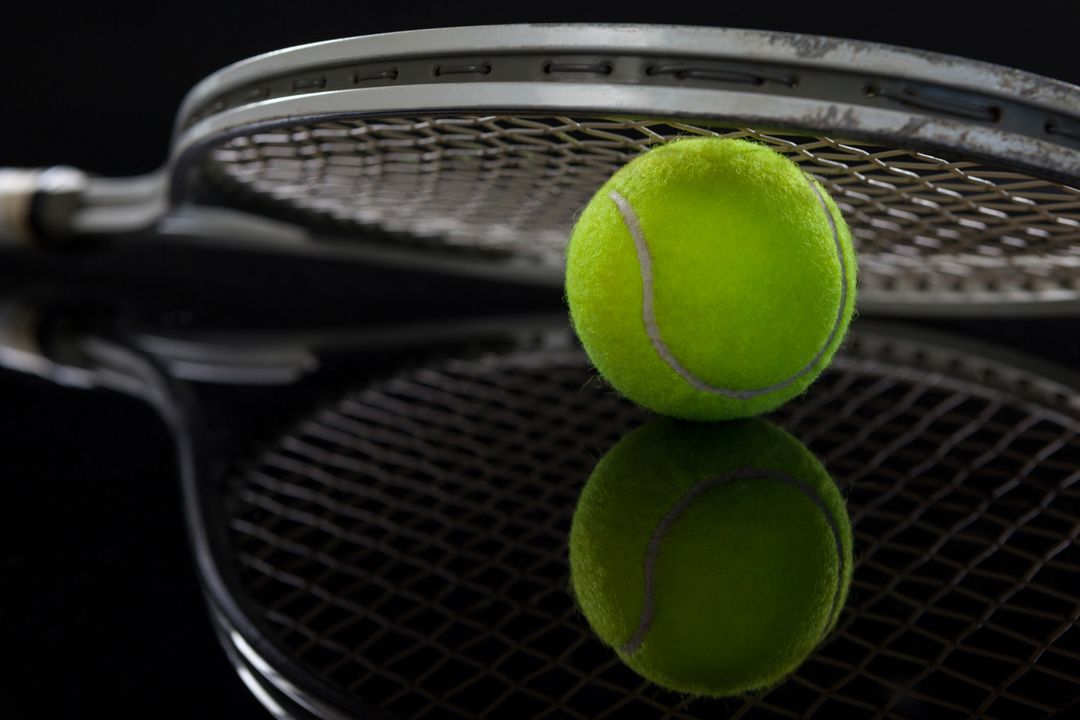 Close Up of Tennis Racket and Ball with Reflection on Black Background - Free Images, Stock Photos and Pictures on Pikwizard.com