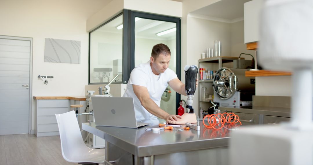 Technician Calibrating Prosthetic Arm in Modern Workshop