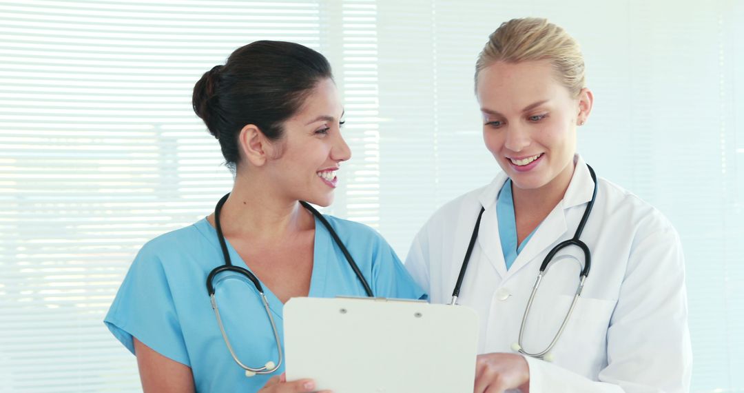 Two Medical Professionals Discussing Patient Chart in Hospital - Free Images, Stock Photos and Pictures on Pikwizard.com