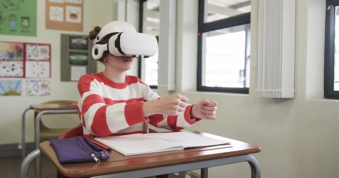 Girl Wearing VR Headset in Classroom Studying with Notebook