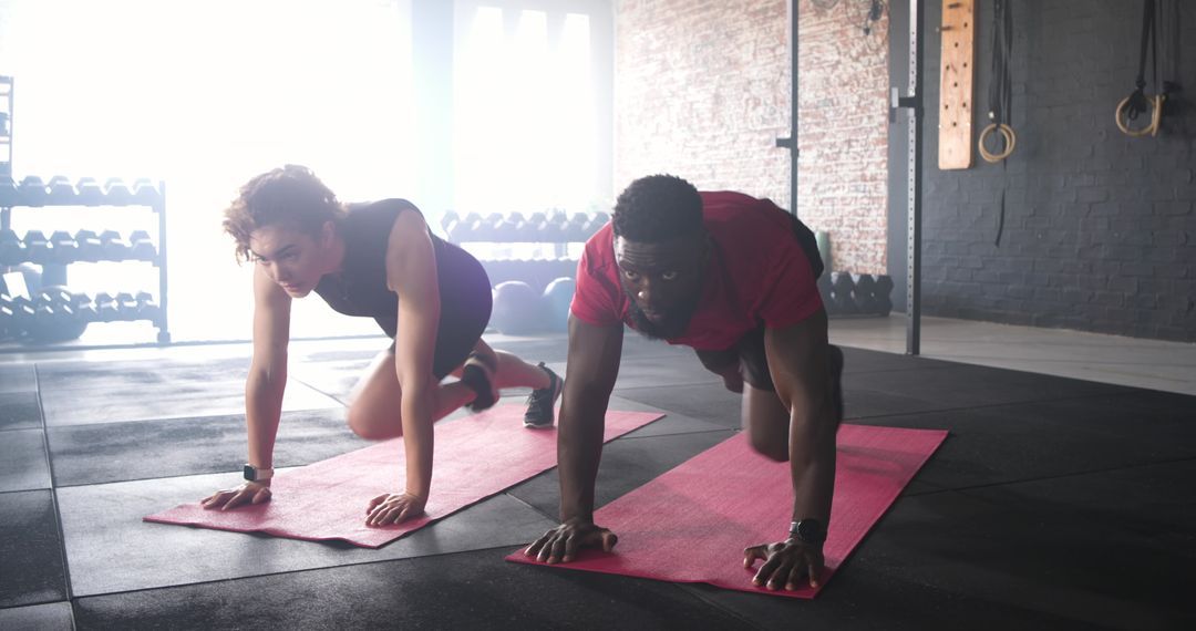 Diverse Couple Practicing Mountain Climbers in Modern Gym