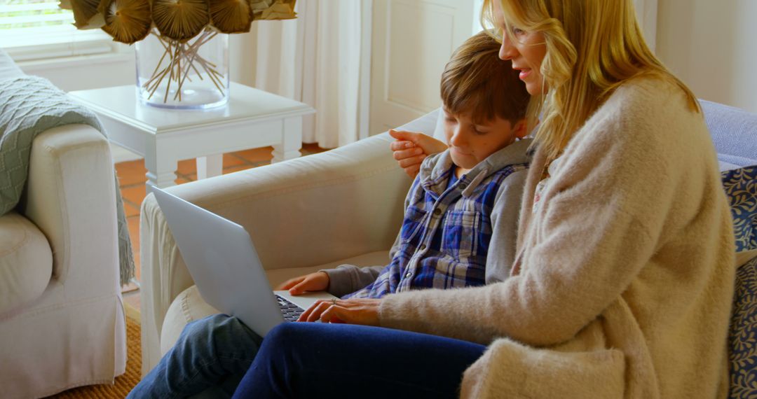 Mother Helping Son with Homework on Laptop at Home - Free Images, Stock Photos and Pictures on Pikwizard.com