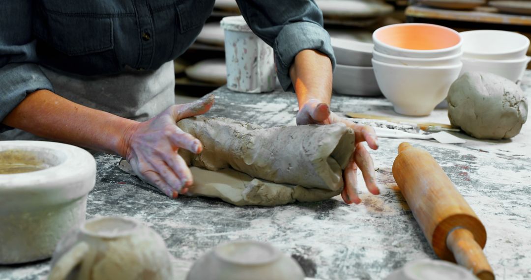 Artist Shaping Clay on Workbench in Pottery Studio - Free Images, Stock Photos and Pictures on Pikwizard.com