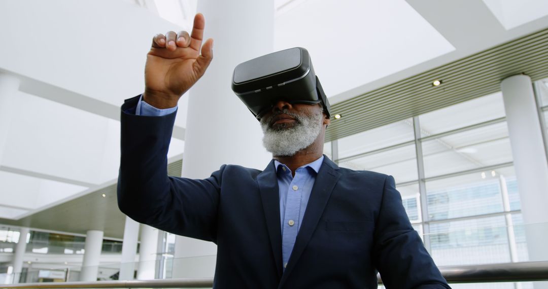 Mature African American Man Using Virtual Reality Headset in Modern Office - Free Images, Stock Photos and Pictures on Pikwizard.com