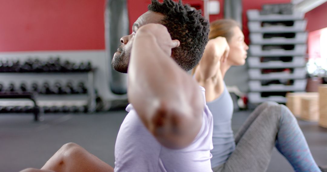 Diverse Gym Partners Focused on Intense Workout Routine
