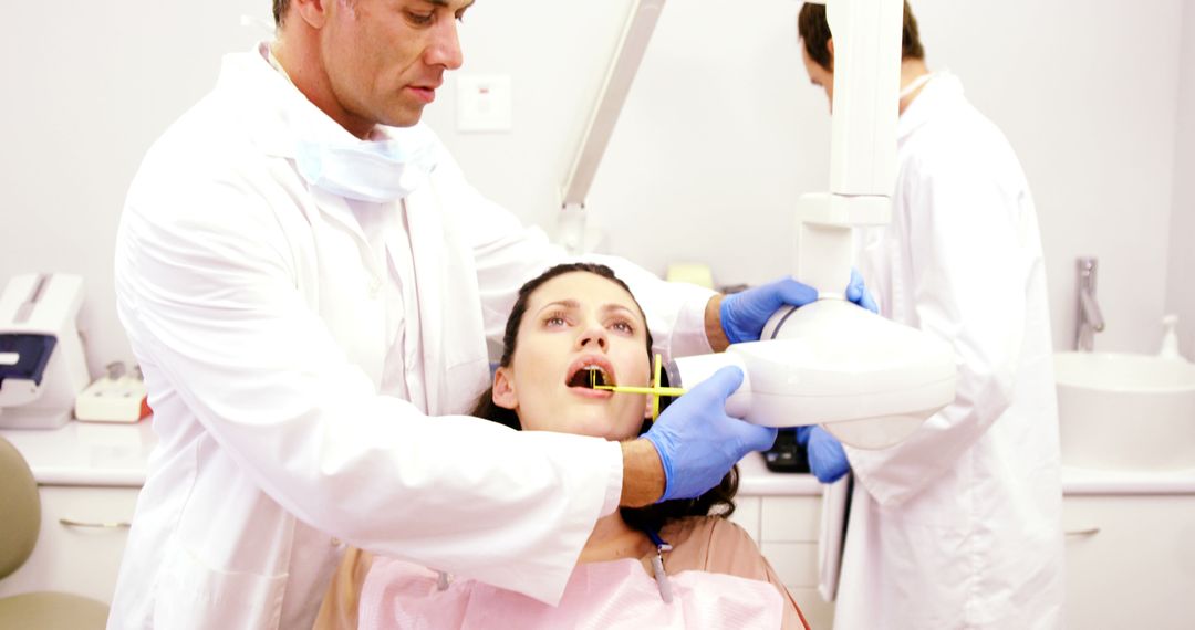 Dentist Taking X-Ray Image of Woman's Teeth During Dental Exam - Free Images, Stock Photos and Pictures on Pikwizard.com