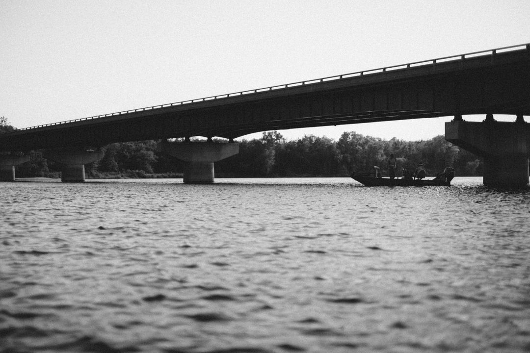 Black and White View of a Bridge Overwater with a Boat - Free Images, Stock Photos and Pictures on Pikwizard.com