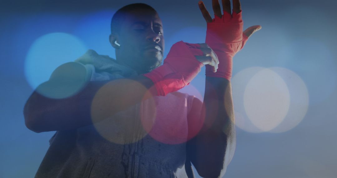 Athletic Boxer Wrapping Hands with Red Handwraps for Training