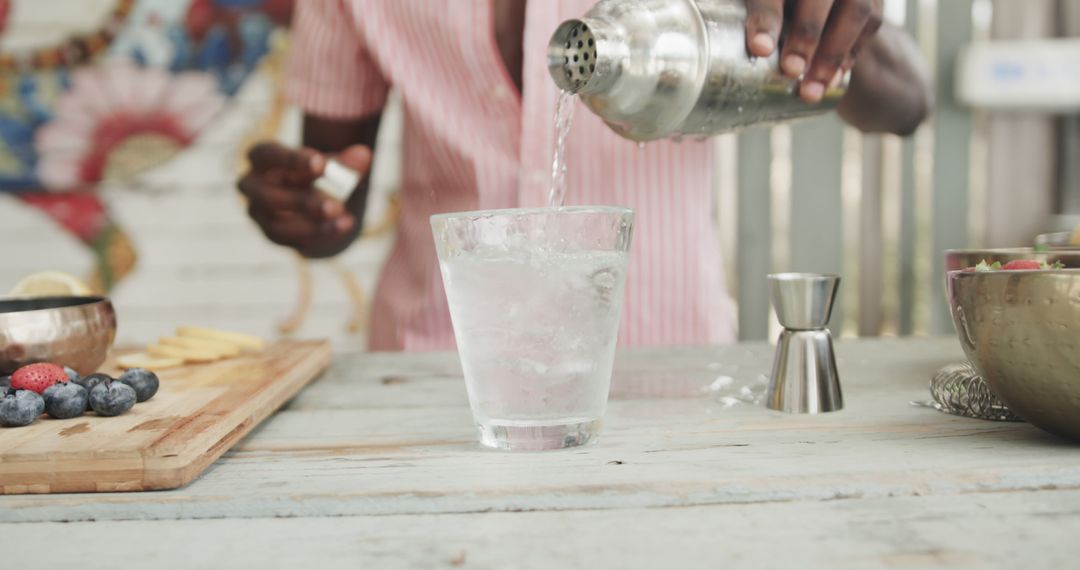 Bartender Preparing Refreshing Drink at Stylish Beach Bar