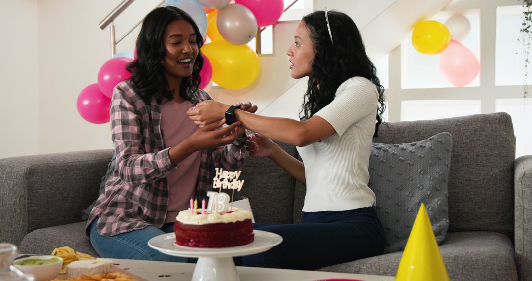 Joyful birthday celebration with cake and gift exchange