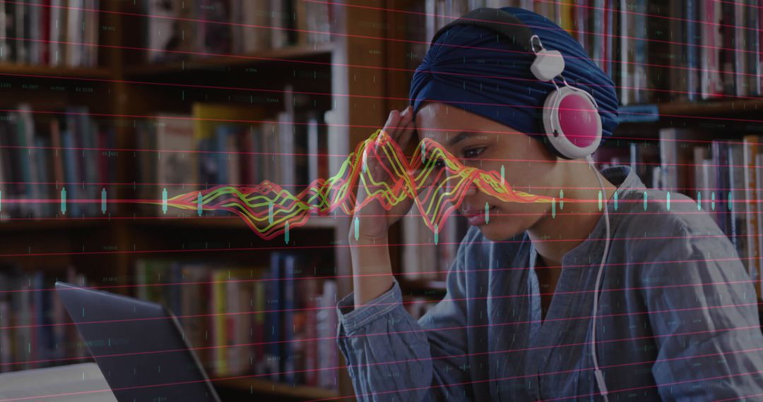 Student Analyzing Data on Laptop in Library Environment