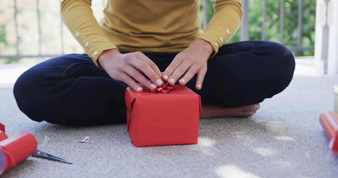 Person Wrapping Red Gift Box With Ribbon - Free Images, Stock Photos and Pictures on Pikwizard.com