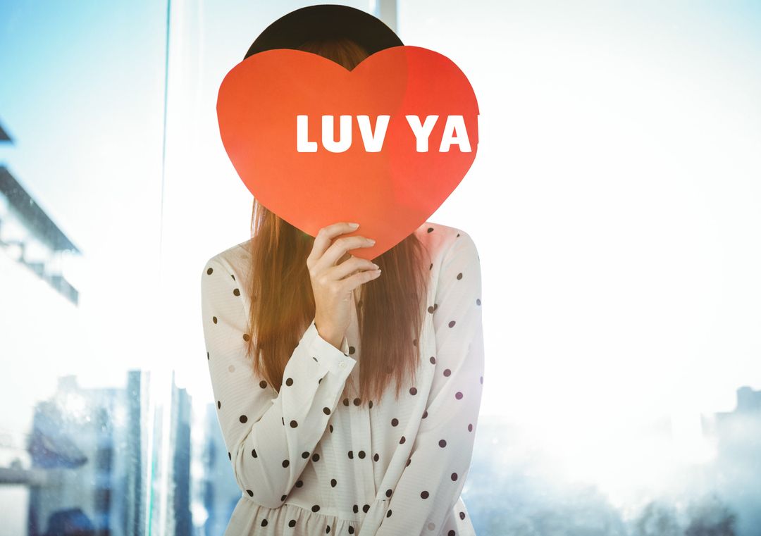 Woman Holding Heart-Shaped Sign with LUV YA Text - Download Free Stock Templates Pikwizard.com