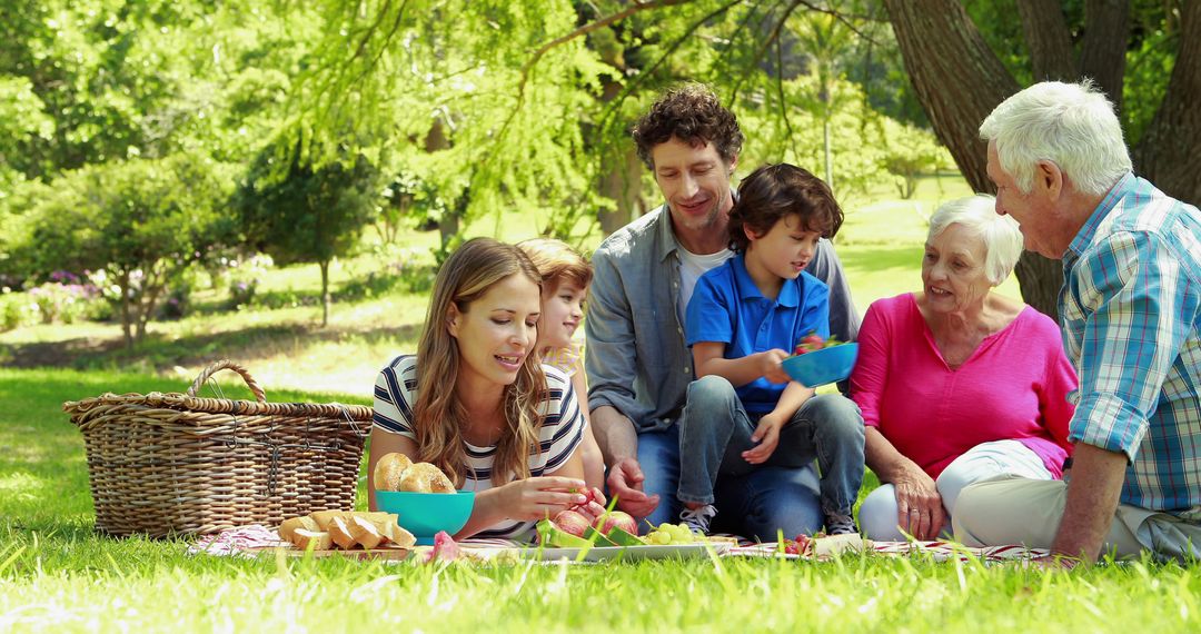 Multigenerational Family Enjoying Picnic in Sunny Park - Free Images, Stock Photos and Pictures on Pikwizard.com