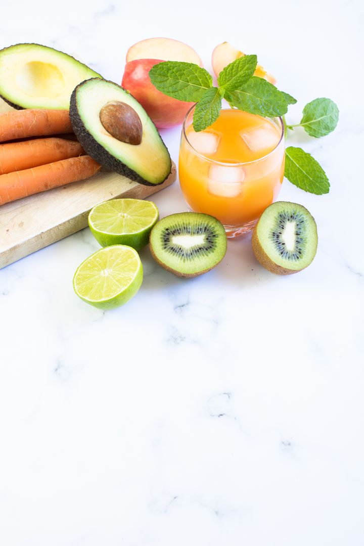 Fresh Kiwi and Avocado Beverage with Mint on Marble Surface