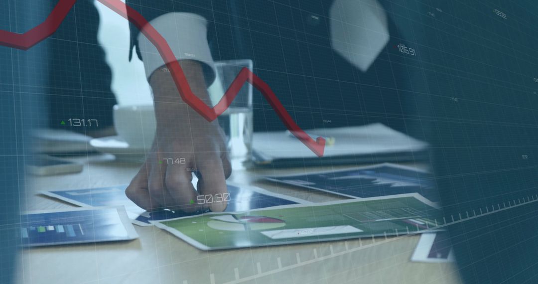 Businessman Analyzing Financial Charts with Red Line Graph