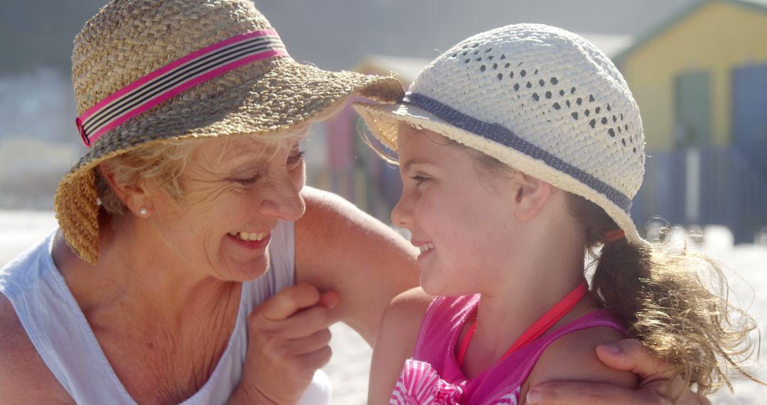 Happy Grandmother and Granddaughter Smiling at Beach - Free Images, Stock Photos and Pictures on Pikwizard.com