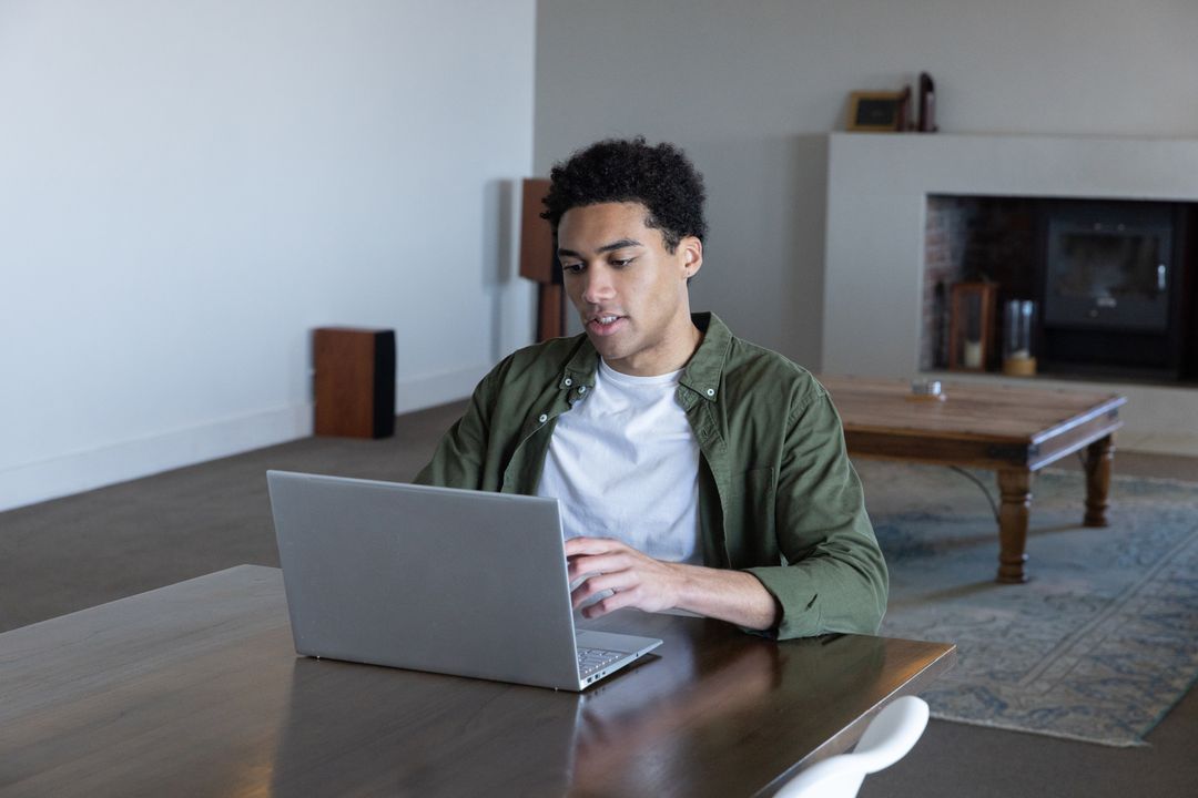 Focused Man Typing on Computer in Modern Living Space