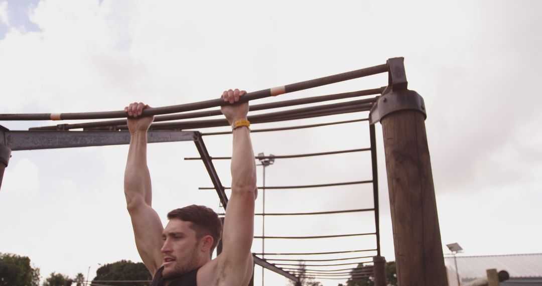 Man Exercising Outdoors Holding Monkey Bars - Free Images, Stock Photos and Pictures on Pikwizard.com