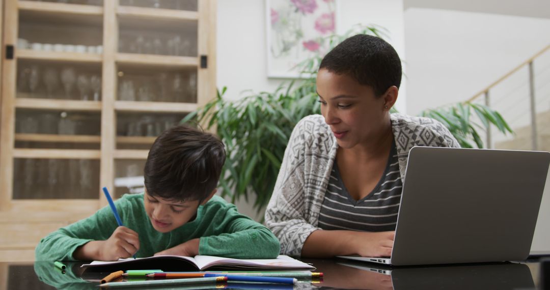 Mother Encouraging Son Doing Homework at Home - Free Images, Stock Photos and Pictures on Pikwizard.com