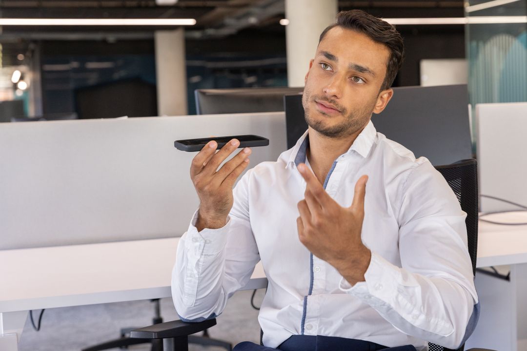 Professional Man Communicating via Smartphone in Modern Office