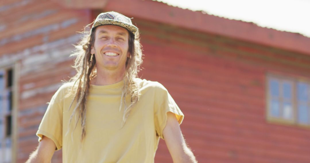 Smiling Man Standing Outdoors with Rustic Red Barn Background - Free Images, Stock Photos and Pictures on Pikwizard.com