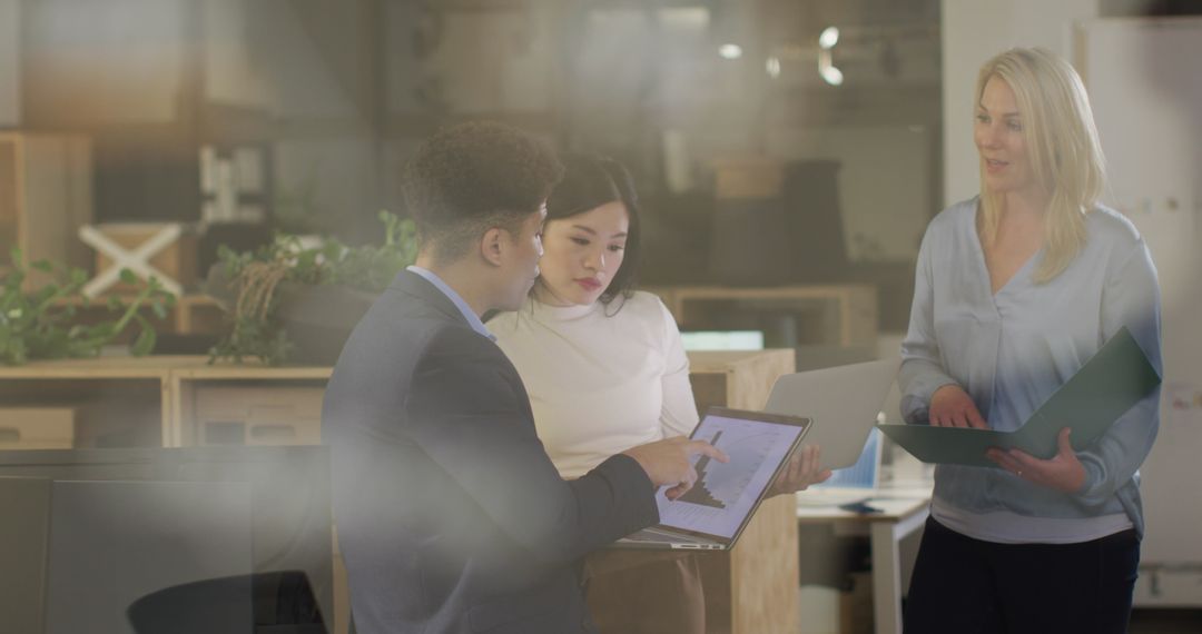 Diverse Team Collaboration on Project in Modern Office