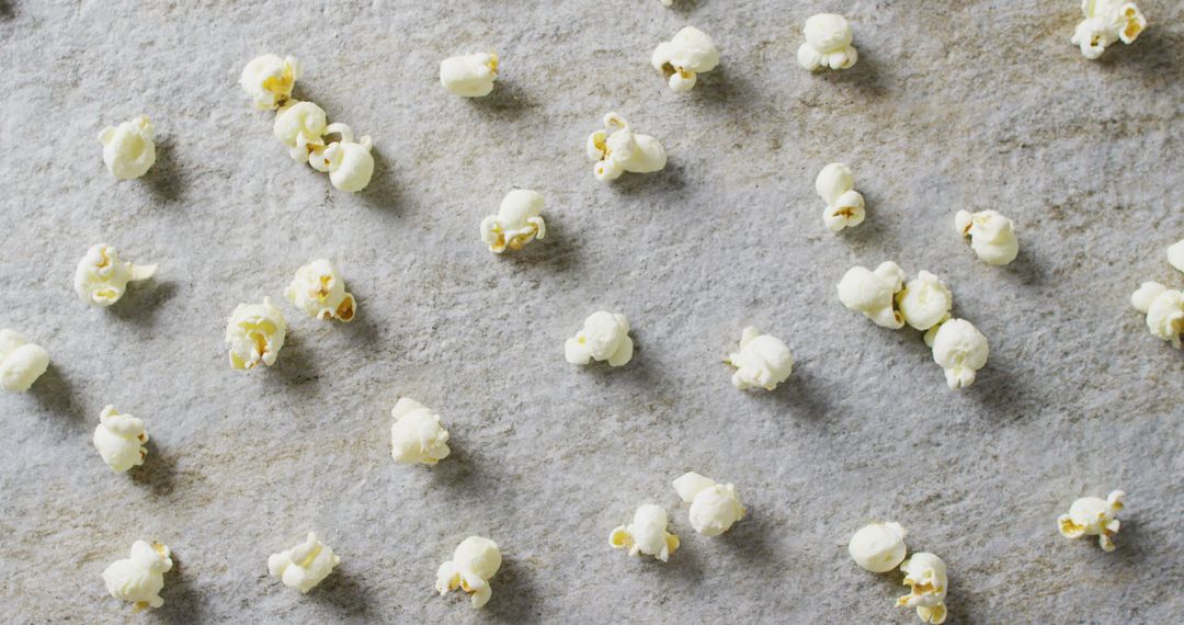 Scattered Fresh Popcorn on Gray Surface