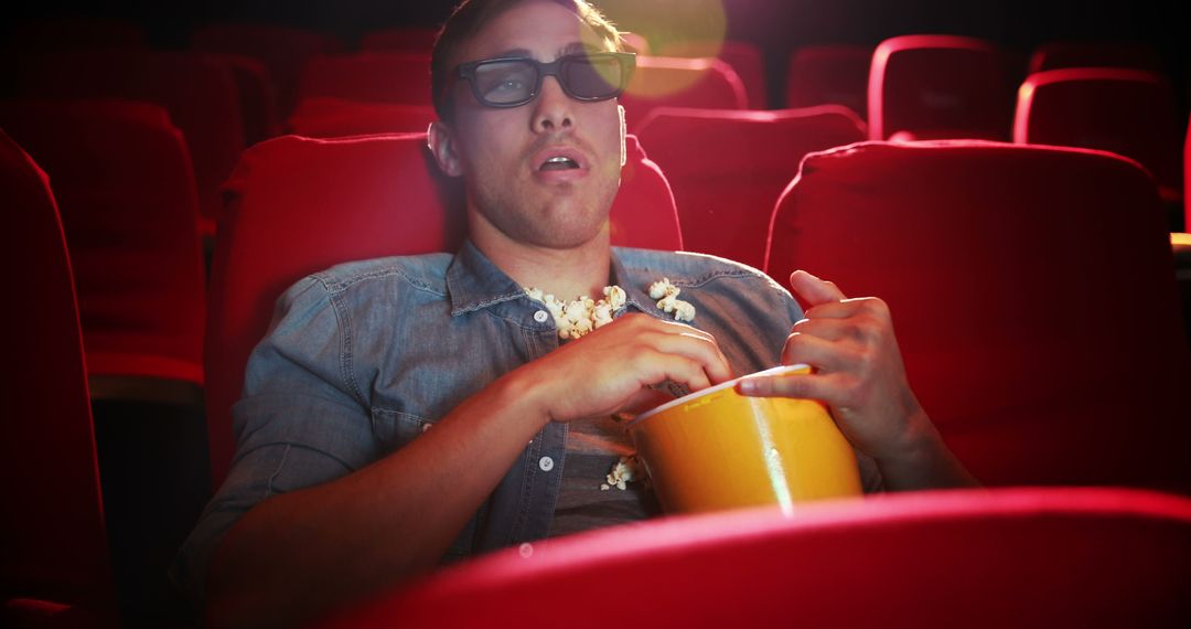 Man Watching 3D Movie in Theater with Popcorn - Free Images, Stock Photos and Pictures on Pikwizard.com