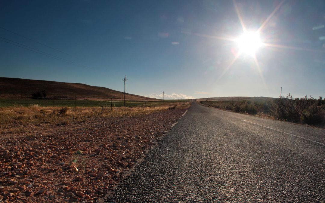 Sunlit Desert Road Under Bright Sky - Free Images, Stock Photos and Pictures on Pikwizard.com