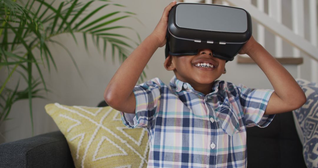 Boy Exploring Virtual Reality, Smiling in Living Room - Free Images, Stock Photos and Pictures on Pikwizard.com