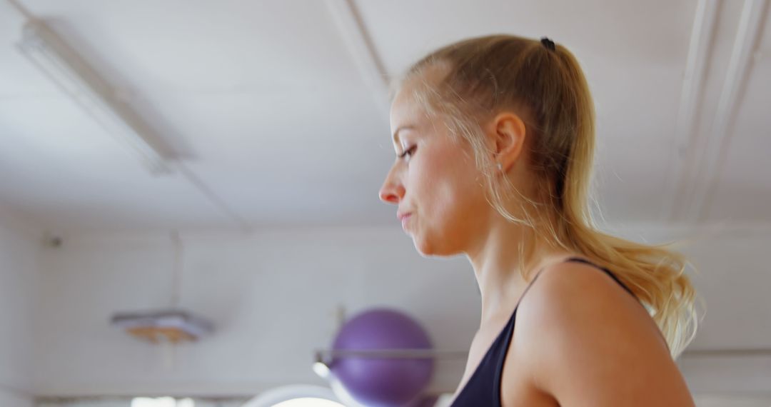 Young Woman Focused on Exercise in Gymnasium - Free Images, Stock Photos and Pictures on Pikwizard.com