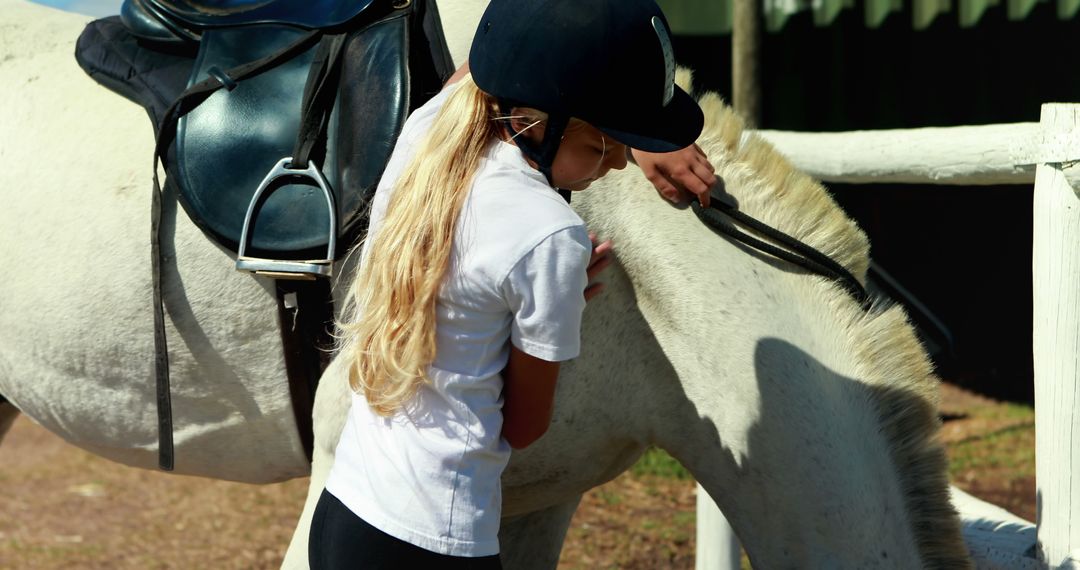 Young Girl Preparing Horse for Riding at Equestrian Center - Free Images, Stock Photos and Pictures on Pikwizard.com