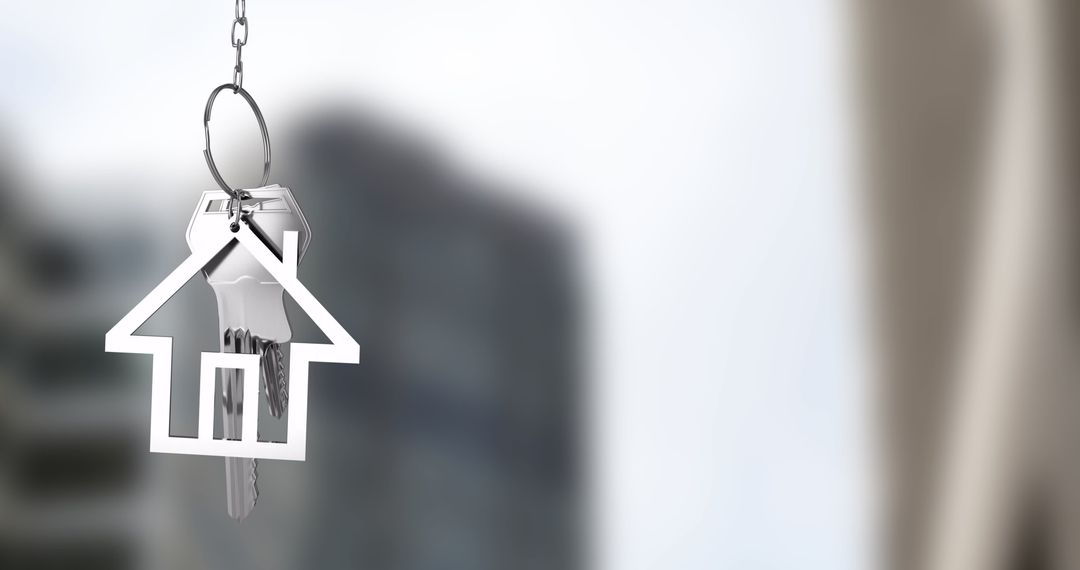 House-Shaped Keychain Dangles in Front of Blurred Cityscape