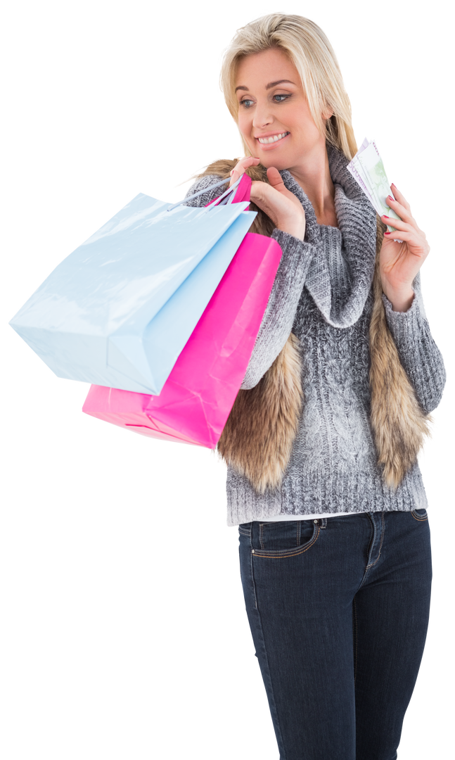 Blonde woman in winter clothes holding shopping bags looking at money with transparent background - Download Free Stock Images Pikwizard.com