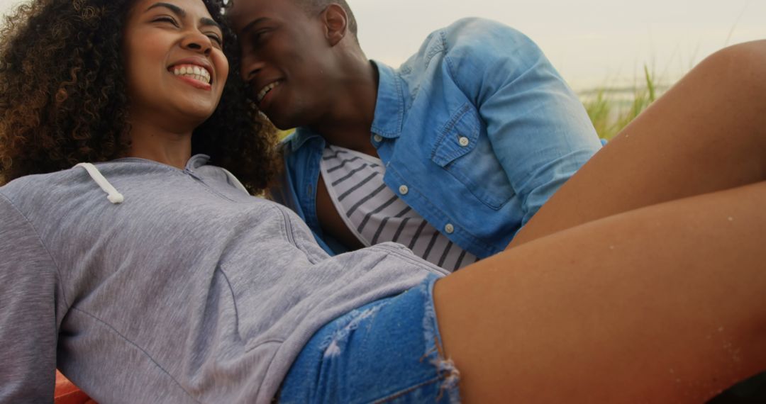Happy Couple Relaxing on Beach in Casual Attire