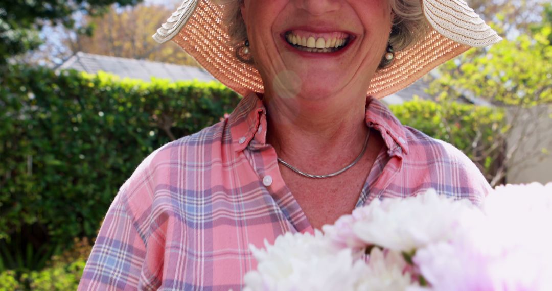 Smiling Senior Woman Enjoying Gardening on a Sunny Day - Free Images, Stock Photos and Pictures on Pikwizard.com