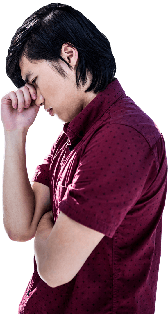 Transparent Young Asian Man Worriedly Holding Head in Thought