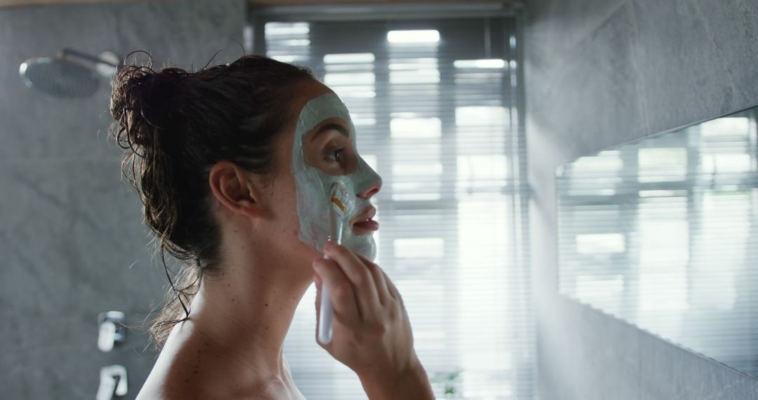 Woman Applying Facial Mask in Modern Bathroom - Free Images, Stock Photos and Pictures on Pikwizard.com