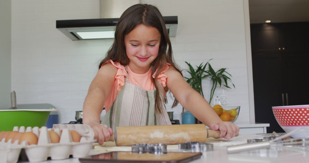 Young Girl Rolling Dough in Kitchen with Baking Ingredients - Free Images, Stock Photos and Pictures on Pikwizard.com