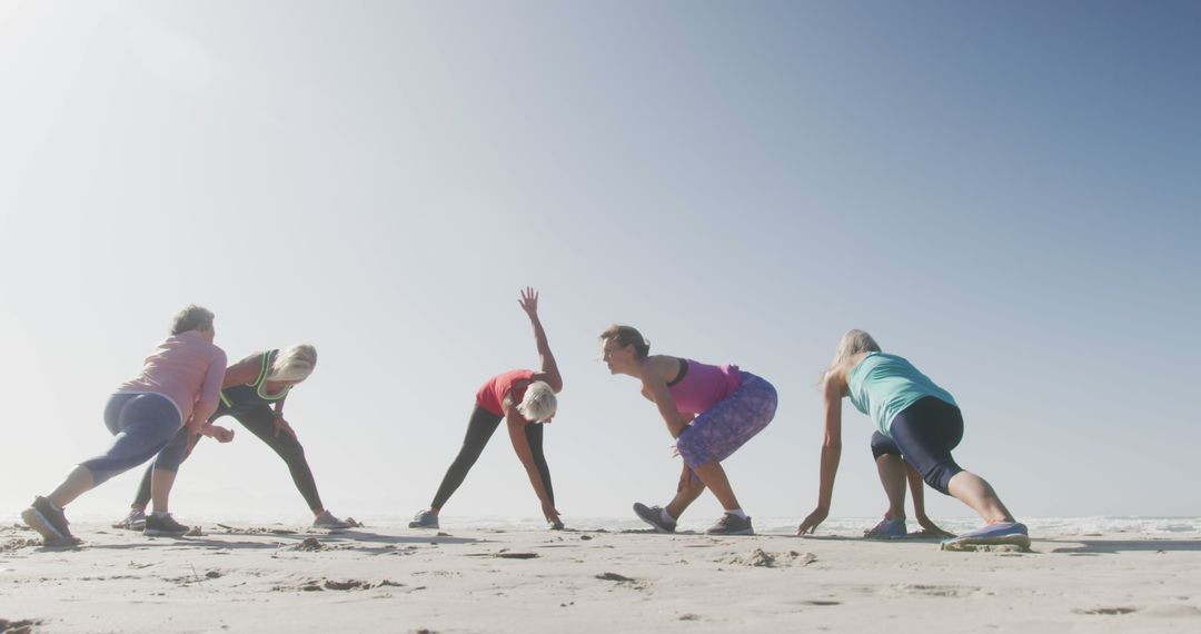 Group of Elderly Women Doing Stretching Exercises on Beach - Free Images, Stock Photos and Pictures on Pikwizard.com