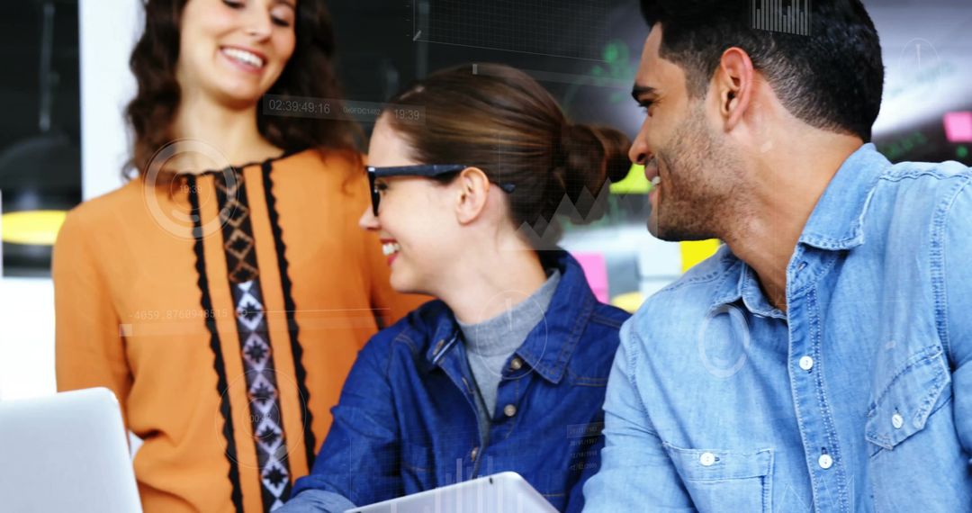 Team Collaborating on Laptop in Bright Office