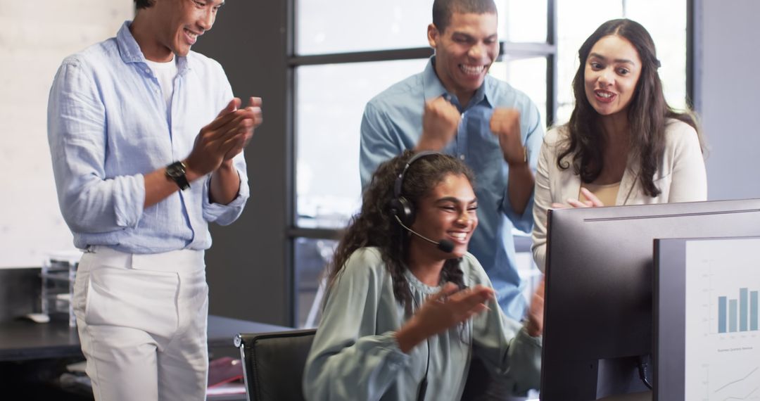Diverse Office Team Celebrating Online Success at Computer