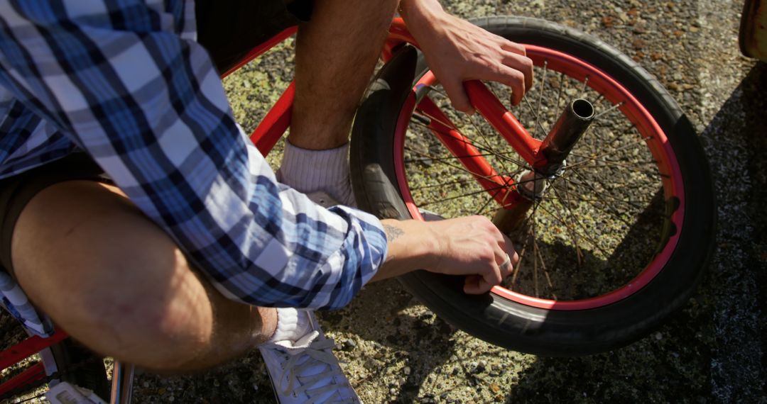 Person Repairing Red Bicycle on Sunny Day - Free Images, Stock Photos and Pictures on Pikwizard.com