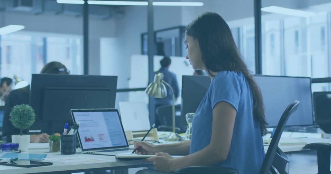 Focused Young Professional Analyzing Data in Modern Office