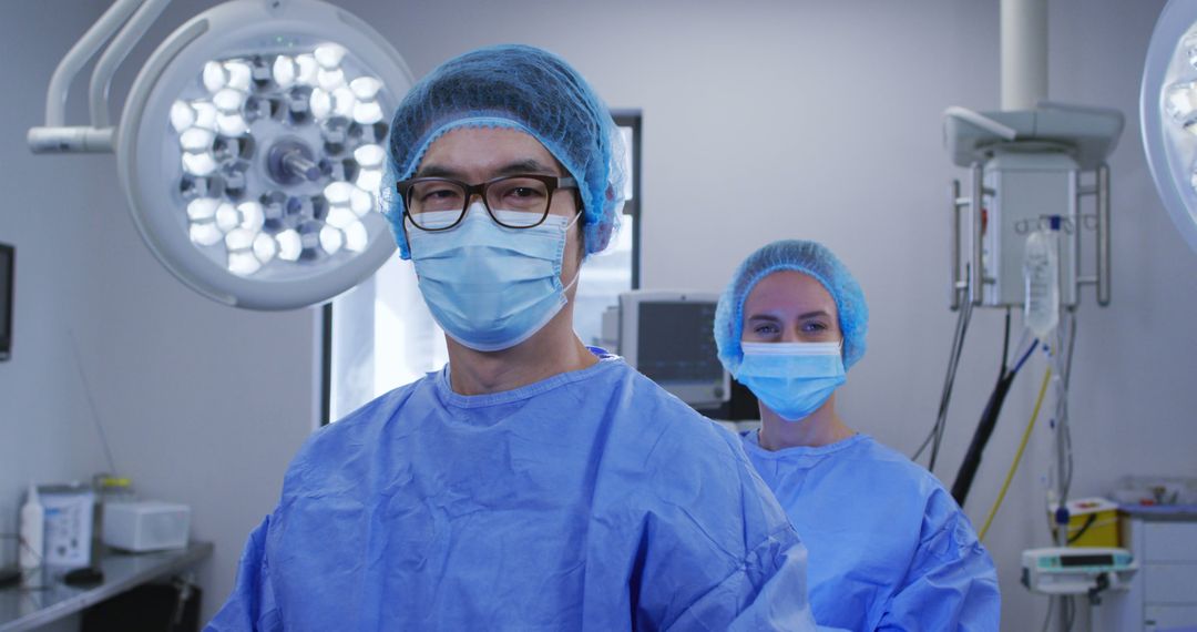 Medical Team in Surgical Theater Wearing Protective Gear and Face Masks - Free Images, Stock Photos and Pictures on Pikwizard.com