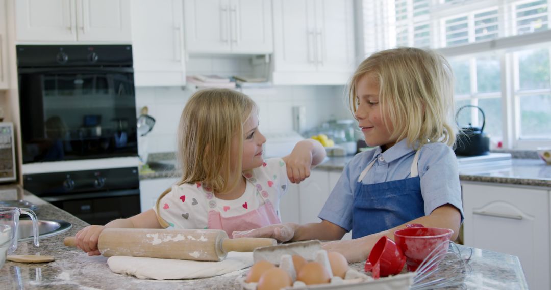 Siblings Baking Together in a Bright Kitchen - Free Images, Stock Photos and Pictures on Pikwizard.com