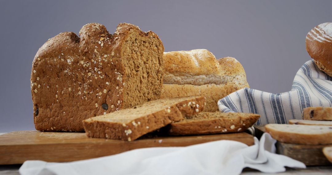 Sliced Whole Grain Loaves on Wooden Board in Rustic Setting - Free Images, Stock Photos and Pictures on Pikwizard.com