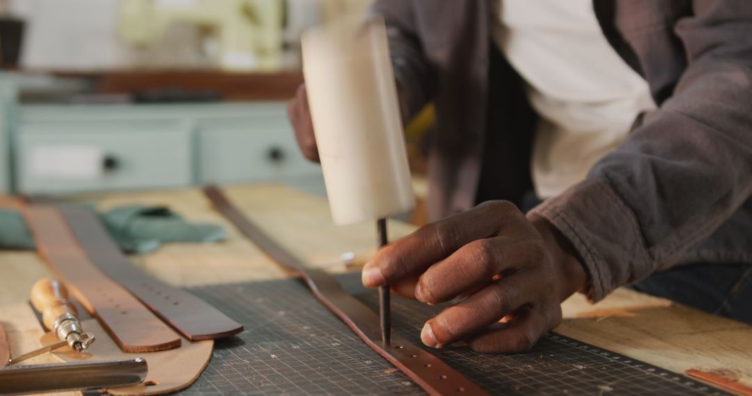 Hands Creating Leatherware in Artisan Workshop